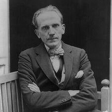 Black and white photograph of A.A. Milne in a suit with a bowtie, earlier 1900s