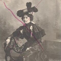Sepia image of a woman in late 1800s dress with a red X drawn through her