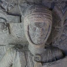 Close up of the face of a stone effigy of a knight