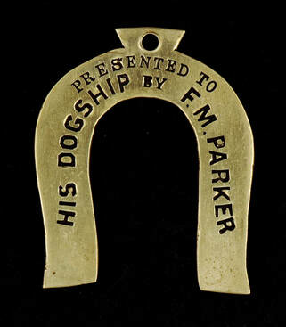 This horseshoe-shaped metal tag includes the inscription that it was presented to “His Dogship by F.M.Parker.” The reverse of the tag includes the date April 20, 1892, and the railway line, the Baltimore and Grafton Railway Post Office (RPO) car.