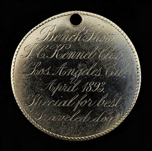Round metal tag that says Bench show. S.C. Kennel Club. Los Angeles, Cal. April 1893. Special for best traveled dog.